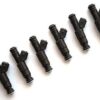 A set of six black plastic spray nozzles arranged diagonally on a light background.