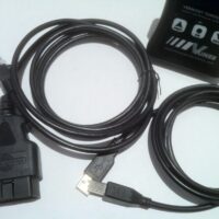 Usb cables and a vehicle tuning device on a white surface.