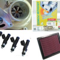 Car engine turbocharger, iridium spark plugs, fuel injectors, and high-performance air filter.