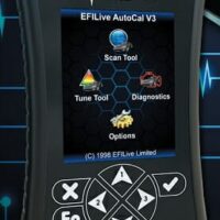 Handheld automotive diagnostic device displaying menu options for scanning, tuning, and diagnostics.