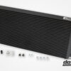 High-performance aftermarket car intercooler with installation components.