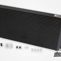 High-performance aftermarket car intercooler with installation components.